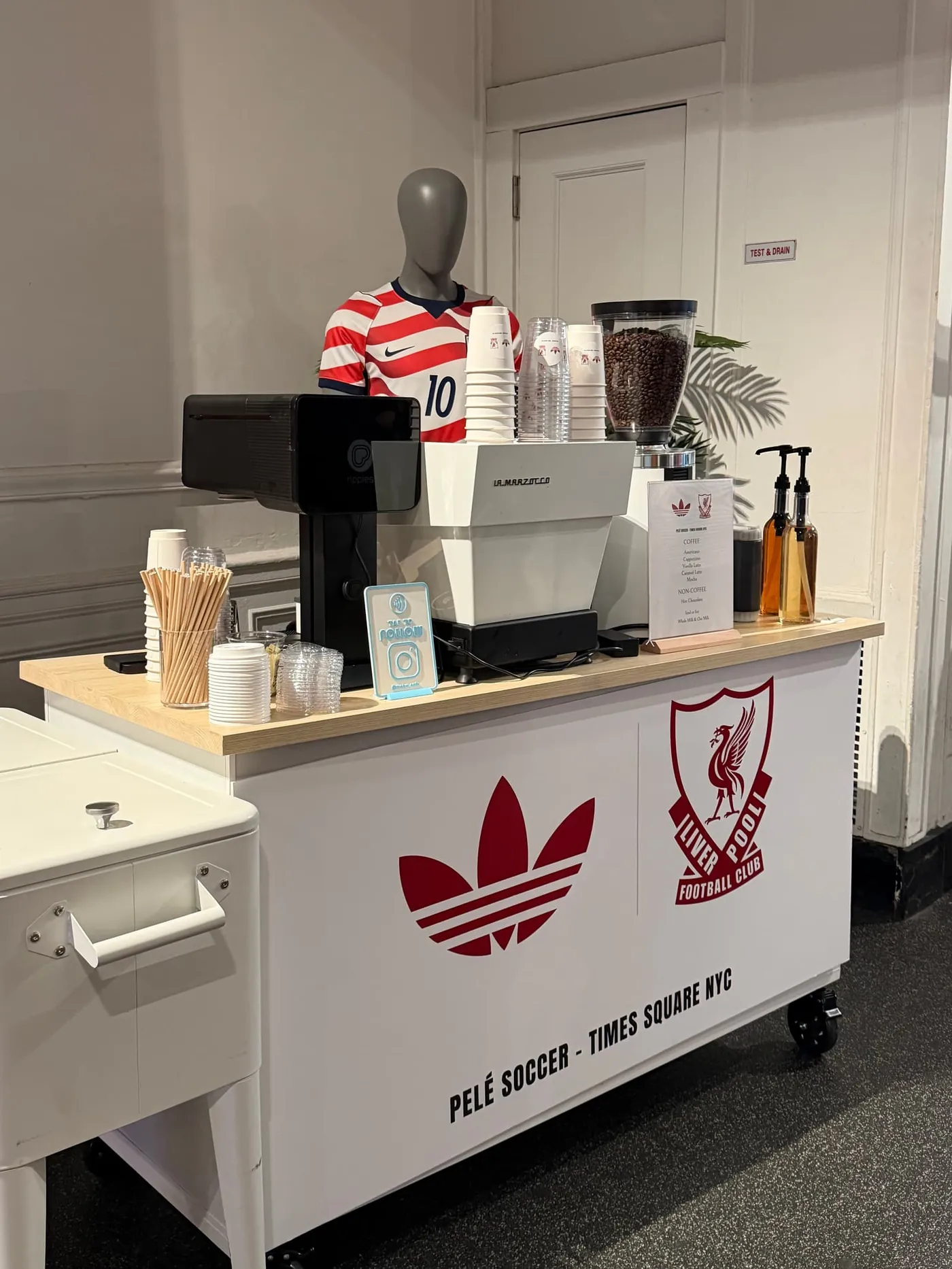 White coffee cart branded with adidas and Pelé Soccer Times Square NYC