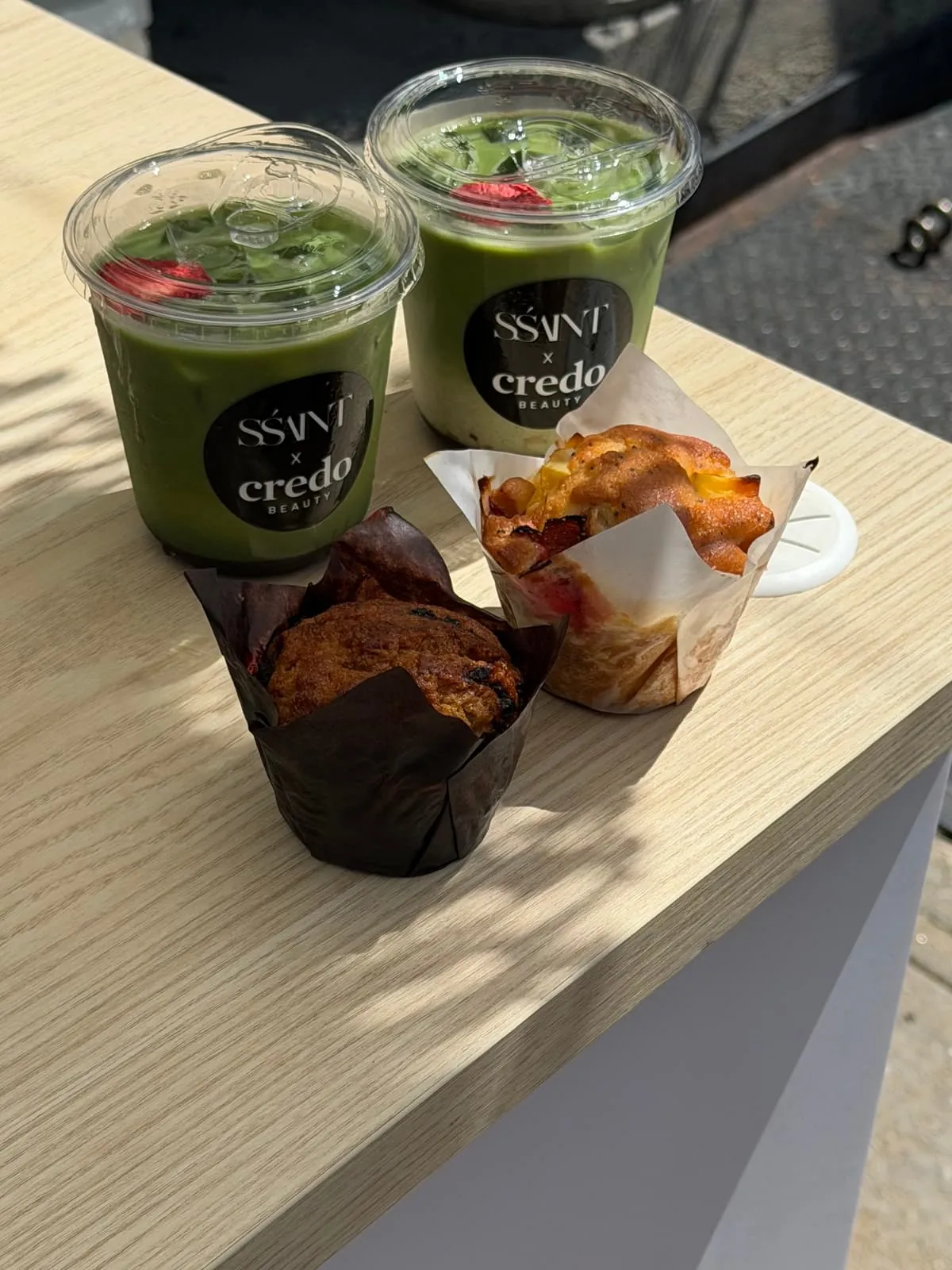 Two iced matcha lattes in branded cups